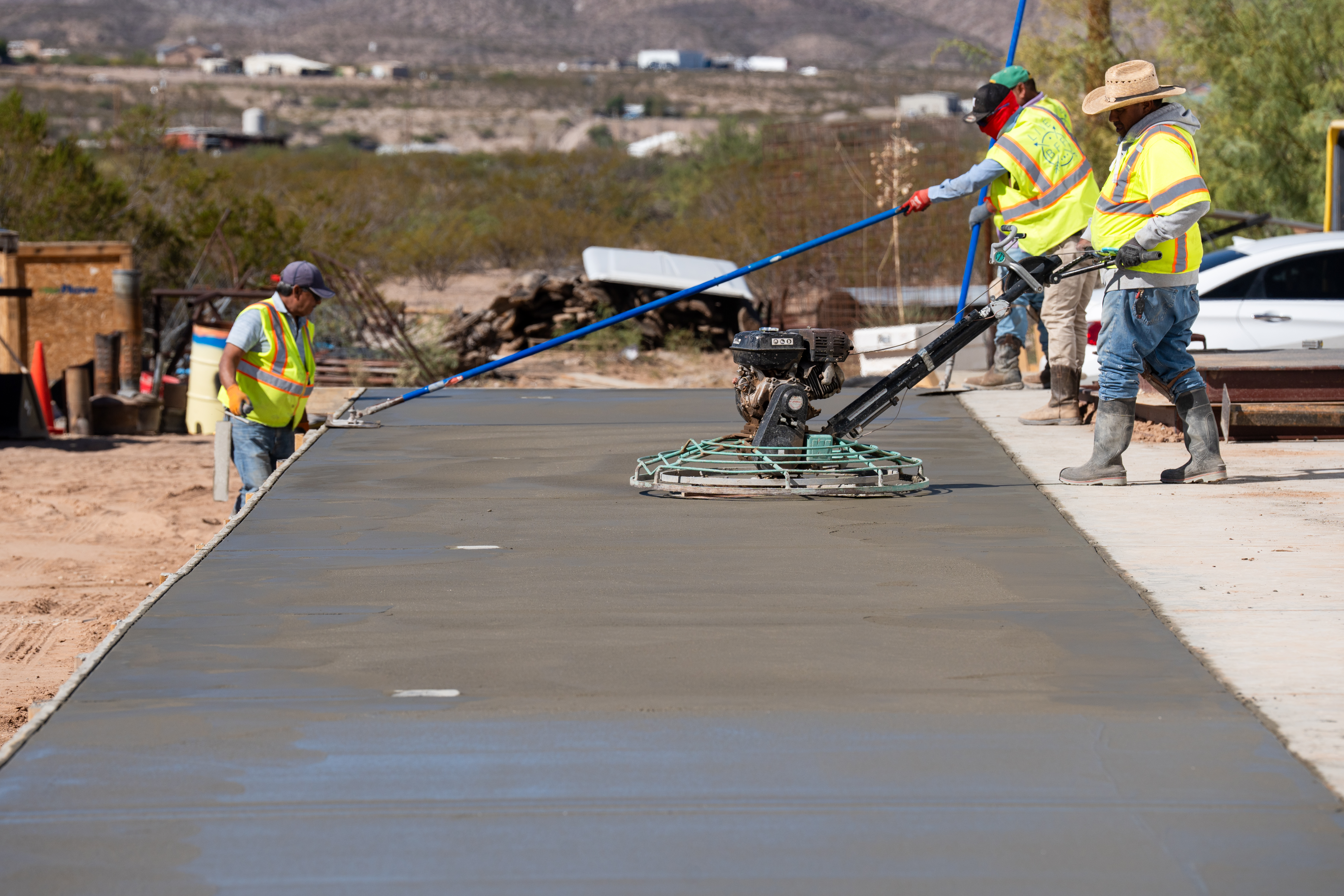 Crew power-troweling a fresh concrete pour